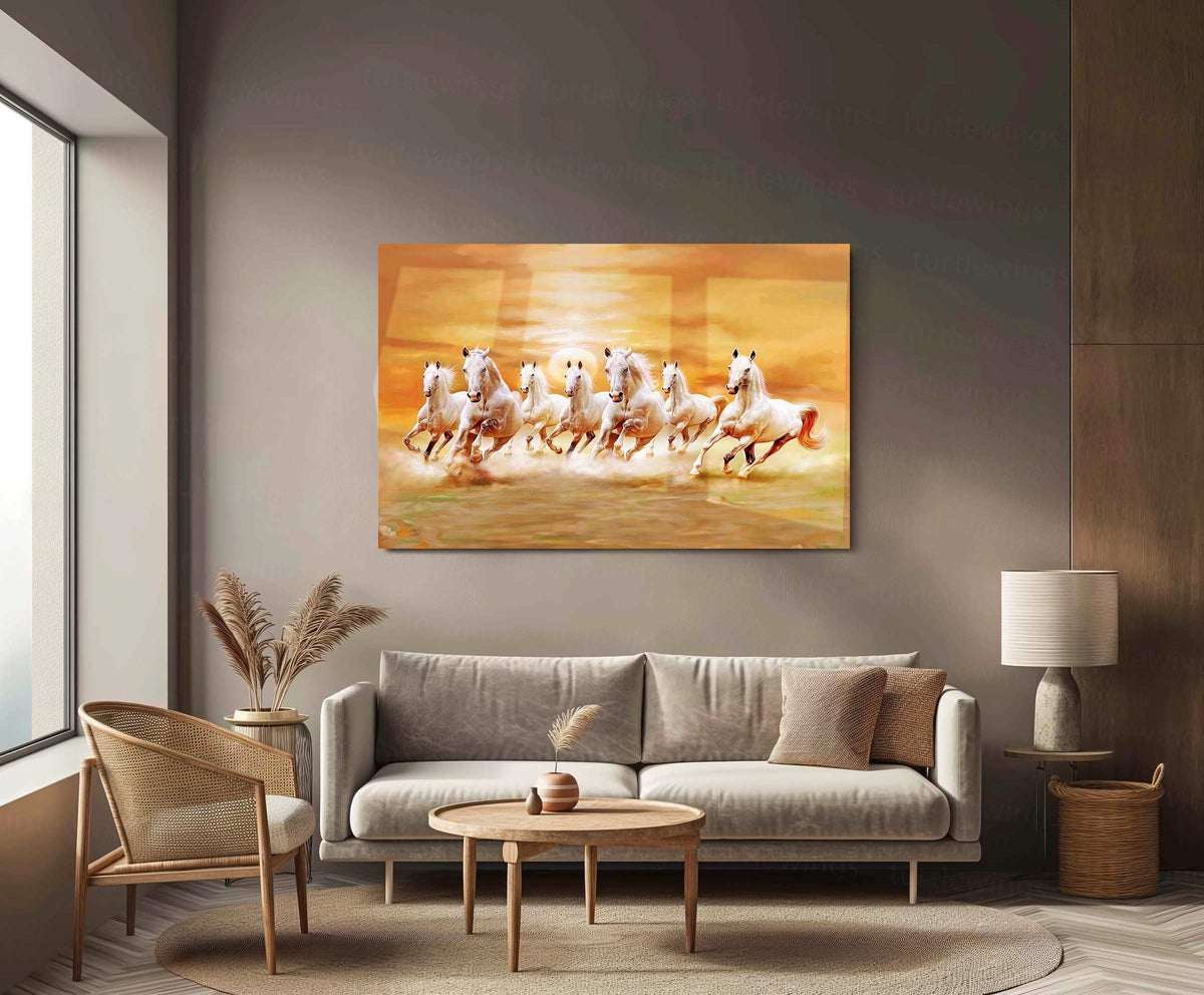 Modern living room with beige sofa, wooden chair and round table featuring a metal print of eight white horses running in warm sunset tones